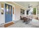 Inviting front porch with blue door and wicker rocking chairs at 832 Heather Ln, Charlotte, NC 28209