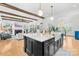 Open kitchen with island, white quartz countertops, and dark cabinetry at 832 Heather Ln, Charlotte, NC 28209