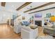 Living room with hardwood floors, exposed beams, and a fireplace, view of staircase and kitchen at 832 Heather Ln, Charlotte, NC 28209