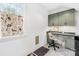 Bright home office with built-in green cabinets and a desk at 832 Heather Ln, Charlotte, NC 28209