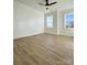 Bright bedroom with light wood floors, ceiling fan, and shiplap accent wall at 8823 Wingard Rd, Waxhaw, NC 28173