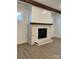 Living room fireplace has white brick surround and a wooden mantle at 8823 Wingard Rd, Waxhaw, NC 28173