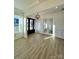 Bright living room with light colored walls, modern light fixture, and french doors at 8823 Wingard Rd, Waxhaw, NC 28173