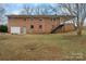 Back of all brick house featuring a garage, a patio space, a backyard, and exterior stairs at 925 37Th Sw St, Hickory, NC 28602