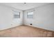 Simple bedroom with carpet flooring, bright windows, and neutral paint at 925 37Th Sw St, Hickory, NC 28602