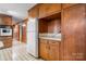 Cozy kitchen featuring wooden cabinets, white appliances, and retro-style flooring at 925 37Th Sw St, Hickory, NC 28602