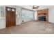 Cozy living room featuring a brick fireplace, ceiling fan, and carpet flooring at 925 37Th Sw St, Hickory, NC 28602