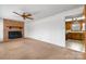 Comfortable living room features a fireplace, ceiling fan, and view into the kitchen at 925 37Th Sw St, Hickory, NC 28602