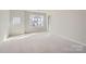 Spacious bedroom with carpeted floors and large windows at 9835 Old Garden Cir, Gastonia, NC 28056