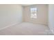 Bright bedroom with neutral walls and carpet at 9835 Old Garden Cir, Gastonia, NC 28056