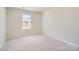 Bright bedroom with carpeted floor and large window at 9839 Old Garden Cir, Gastonia, NC 28056