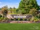 Community entrance with stone wall and landscaping at 9839 Old Garden Cir, Gastonia, NC 28056