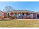 Brick house featuring a covered porch and well-maintained lawn at 116 Country Creek Dr, Kings Mountain, NC 28086