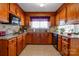 Spacious kitchen with wood cabinets, granite counters, and stainless steel appliances at 116 Country Creek Dr, Kings Mountain, NC 28086