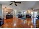 Large living room with hardwood floors, multiple seating areas, and ceiling fan at 116 Country Creek Dr, Kings Mountain, NC 28086