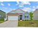 Brick and blue-sided house with a two-car garage and well-manicured lawn at 123 Neill Estate Ln, Mooresville, NC 28117