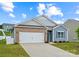 Two-car garage, brick and blue-sided house with landscaping at 123 Neill Estate Ln, Mooresville, NC 28117