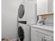 Modern laundry room with stacked washer and dryer and marble countertop at 1259 Amberlight Cir, Salisbury, NC 28144