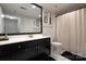 Stylish bathroom with dark vanity, white countertop, and elegant shower curtain at 1315 East Blvd # 420, Charlotte, NC 28203