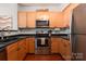 Well-equipped kitchen with light wood cabinets and stainless steel appliances at 1315 East Blvd # 420, Charlotte, NC 28203