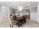 Elegant dining room with a large wood table and chandelier at 13505 Evening Primrose Dr, Davidson, NC 28036