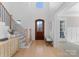 Light-filled entryway, hardwood floors, and arched front door at 13505 Evening Primrose Dr, Davidson, NC 28036