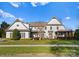 Two story home with white siding, a covered porch, and neatly landscaped lawn at 13505 Evening Primrose Dr, Davidson, NC 28036