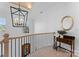 Open staircase with a wooden railing, chandelier, and decorative mirror at 13505 Evening Primrose Dr, Davidson, NC 28036