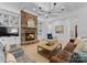 Living room with stone fireplace, built-in shelving, hardwood floors, and large windows at 13505 Evening Primrose Dr, Davidson, NC 28036