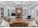 Cozy living room with stone fireplace, built-in shelving, and hardwood floors at 13505 Evening Primrose Dr, Davidson, NC 28036