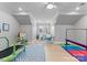 Spacious playroom with a ' table, mini trampoline, and gymnastics equipment at 13505 Evening Primrose Dr, Davidson, NC 28036