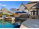 Resort-style pool and hot tub with outdoor seating at 13505 Evening Primrose Dr, Davidson, NC 28036