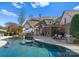 Luxury pool with spa, patio, and outdoor kitchen at 13505 Evening Primrose Dr, Davidson, NC 28036