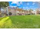 Stone and shingle exterior with a landscaped lawn at 13924 Island Dr, Huntersville, NC 28078