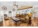 Spacious living room featuring a beamed ceiling, hardwood floors, and a comfortable leather sofa at 13924 Island Dr, Huntersville, NC 28078