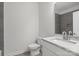 Modern bathroom with grey tile and white vanity at 1420 Beechwood Dr, Gastonia, NC 28052