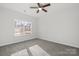 Bright bedroom with gray carpet and ceiling fan at 1420 Beechwood Dr, Gastonia, NC 28052