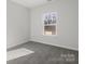 Bright bedroom with grey carpet and large window at 1420 Beechwood Dr, Gastonia, NC 28052