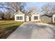 Newly built home with gray and white exterior, a driveway, and landscaping at 1420 Beechwood Dr, Gastonia, NC 28052