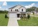 Two-story house with gray and white siding, a two-car garage, and landscaping at 1420 Windy Park Dr, Stanley, NC 28164