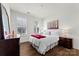 Bright bedroom with a comfortable bed and hardwood floors at 14206 Morningate St, Huntersville, NC 28078