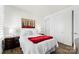 Well-lit bedroom featuring hardwood floors and a red blanket at 14206 Morningate St, Huntersville, NC 28078