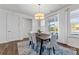 Bright dining room with dark wood table and access to backyard patio at 14206 Morningate St, Huntersville, NC 28078