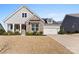 Beautiful two-story home with stone accents and a landscaped lawn at 14206 Morningate St, Huntersville, NC 28078