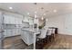 Modern kitchen featuring a large island and white cabinets at 14206 Morningate St, Huntersville, NC 28078