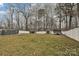 Large backyard featuring well-maintained lawn, pool, sheds, and privacy fence at 1467 Kensington Park Ct, Hickory, NC 28602