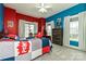 A bedroom features red and blue walls, carpeted flooring, a ceiling fan, and multiple windows at 1467 Kensington Park Ct, Hickory, NC 28602