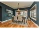 Elegant dining room features hardwood floors, stylish light fixture, and a large window providing ample light at 1467 Kensington Park Ct, Hickory, NC 28602