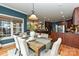 Dining room features a wooden table with seating for six, stylish chandelier, and hardwood floors at 1467 Kensington Park Ct, Hickory, NC 28602