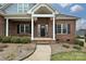 Inviting front porch with classic columns and a brick facade, a welcoming entrance at 1467 Kensington Park Ct, Hickory, NC 28602